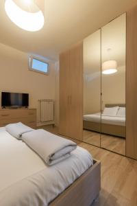 a bedroom with a bed and a mirror at Casa dei Papi - Guest House in Rome
