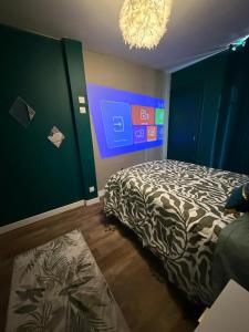 a bedroom with a bed and a blue wall at Le Jungle in Lourdes
