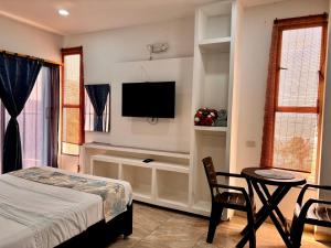 a bedroom with a bed and a table and a tv at Avadia del Mar in Cartagena de Indias