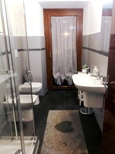 a bathroom with a sink and a toilet and a shower at Bed & Breakfast La Casa Antica in Macomer +35 photos