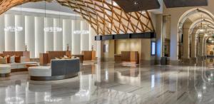 a lobby of a hotel with a couch and chairs at Omni Louisville Hotel in Louisville