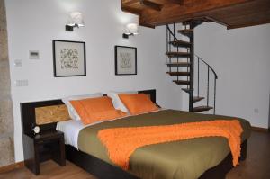 a bedroom with a bed with orange pillows and a staircase at Quinta do Olival in Vilas Boas +77 photos