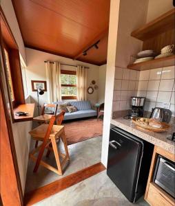 a kitchen and living room with a couch in the background at Chez Ze in Gonçalves