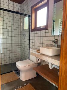 a bathroom with a toilet and a sink at Chez Ze in Gonçalves