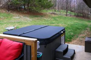 a ping pong table sitting on a porch with a ping pong table at Mountain Cabin w Hot Tub Deck Grill & Fire Pit in Stanley