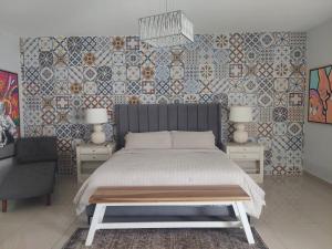 a bedroom with a bed and two tables and a chair at Hotel PZ Country Club & Conference Center in San Isidro +62 photos
