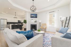 a living room with two couches and a table at Elegant 2 BR apt in the heart of historic SPR - 5 min drive to TIAA Bank Field in Jacksonville
