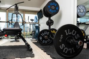 a fitness room with weights and a gym at Hotel Los Españoles Plus in Santiago +95 photos