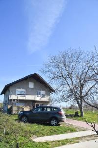 a car parked in front of a house at Dunja in Sivac