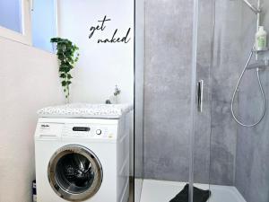 a washing machine in a bathroom with a shower at Fuchsbau mit Kamin & Terrasse & Garten in Winterberg