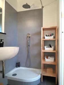 a bathroom with a shower and a sink and a tub at Attico sul Mare By Smart-Home in Genova