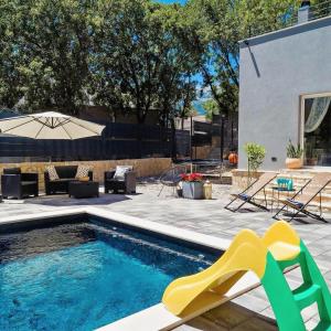 a swimming pool with a slide in a backyard at Villa Andrea in Zagvozd