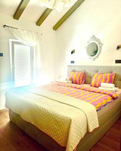 a bedroom with a large bed with colorful pillows at Villa Andrea in Zagvozd +27 photos