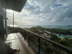 a balcony of a house with a view of the ocean at Serene Sunset Escape - Panoramic Ocean View Apartment in Castries