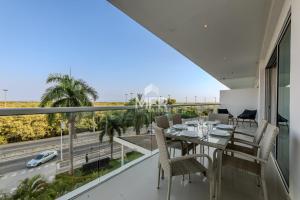 a dining room with a table and chairs on a balcony at Edificio Morros Vitri, 2 Bedrooms- Comfy Apartment in Cartagena de Indias
