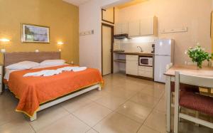 a small room with a bed and a kitchen at Lito Apartments Paleochora in Palaiochora