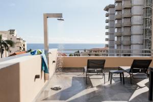 a balcony with chairs and a view of the ocean at Luxurious T2 Varandas Apartment XIII in Funchal