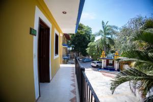 a yellow building with a fence next to a street at Nicte Ha Campeche in Campeche