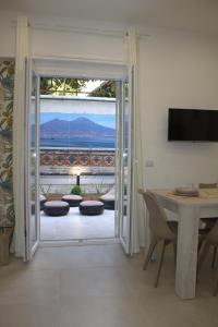 a living room with a door open to a patio at RealeBorbonica-Intero Appartamento Con Ampio Terrazzino in Portici