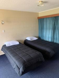 Postel nebo postele na pokoji v ubytování Wayfarer Motel