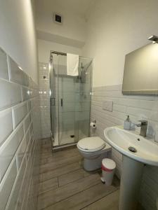 a bathroom with a shower and a toilet and a sink at La Stazione 92 in Catania