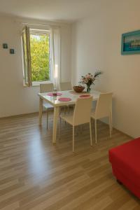 a dining room with a table and chairs at Bilenjki Apartments in Baška Voda