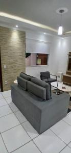 a living room with a couch and a table at Casa Aconchegante in Espirito Santo Do Pinhal