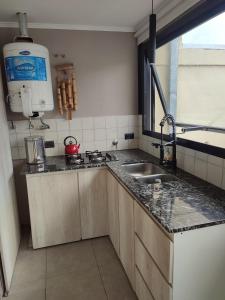 a kitchen with a sink and a counter top at Buena Estadia in Villa María