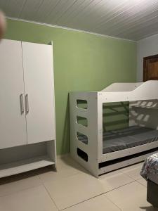 1 dormitorio con litera blanca y armario en Casa da Jessica, en Paraty