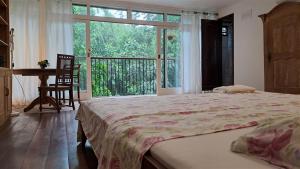 a bedroom with a large bed and a large window at Casa São Conrado in Rio de Janeiro