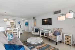 a living room with a couch and chairs and a table at KIHEI BEACH, #109 condo in Kihei