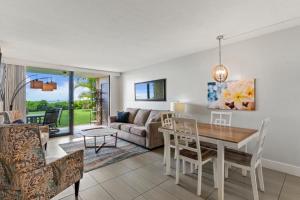 a living room with a table and a couch at KIHEI BEACH, #109 condo in Kihei