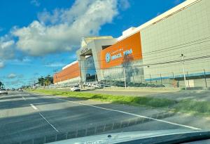 a building on the side of a road next to a street at Residencial MW Novo in Camaçari