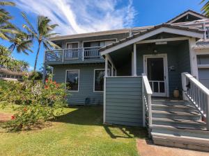 a house with a porch and a balcony at Lanai Villas in Koloa
