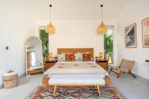 a bedroom with a large bed and a mirror at Villa Casa Blanca, Bingin Beach in Uluwatu +28 photos