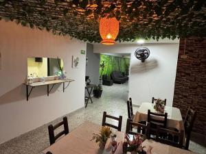 a dining room with a table and a mirror at Hotel JC 43 in Medellín