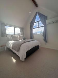 a bedroom with a large bed and a window at A Hidden Gem in Auckland