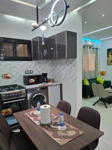 a kitchen with a wooden table and a stove at Seckebe Immo STUDIO VERT in Dakar