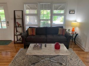 a living room with a couch and a coffee table at Travel Often House in Kennesaw