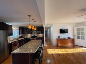 a kitchen with a large island in the middle at Travel Often House in Kennesaw +38 photos