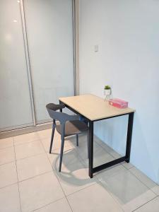 a wooden table and a chair with a box on it at CozyHome - 3 bedroom Town House with unlimited free Wi-Fi in Sitiawan +4 photos