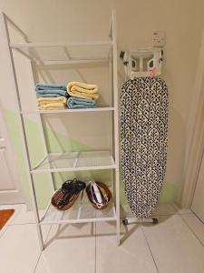 a white shelf with a skateboard in a room at CozyHome - 3 bedroom Town House with unlimited free Wi-Fi in Sitiawan +4 photos