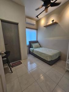 a bedroom with a bed and a ceiling fan at CozyHome - 3 bedroom Town House with unlimited free Wi-Fi in Sitiawan