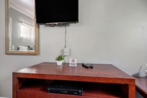 a wooden table with a television on top of it at Warm Private Room in Detroit for Up to 4 w WiFi in Woodhaven +6 photos