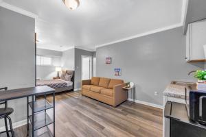 a living room with a couch and a bed at Family-Friendly Room for 4 – High-Speed Wi-Fi in Woodhaven