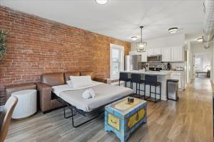 a living room with a couch and a brick wall at downtown Indy with Fire Pit and Free Parking in Indianapolis