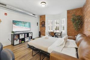 a bedroom with a bed and a couch in a room at downtown Indy with Fire Pit and Free Parking in Indianapolis