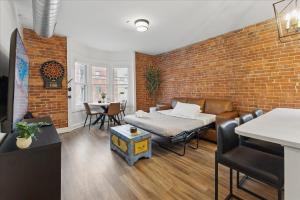 a room with a bed and a brick wall at downtown Indy with Fire Pit and Free Parking in Indianapolis +23 photos
