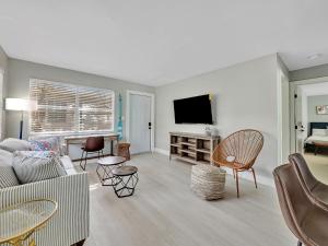 Una sala de estar con un sofá y un televisor. en Beachside 1BR Apt - Walk to Hollywood Dania Beach, en Dania Beach