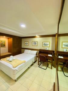 a large bedroom with a bed and a desk at Casa Verde Hotel & Events Center in Imus +44 photos